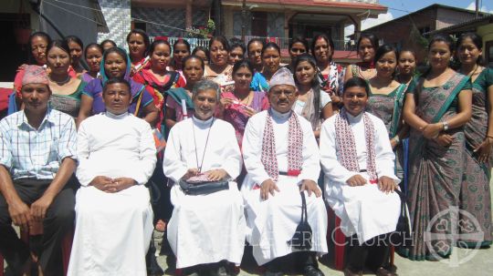 Bishop Dr. Narayan Sharma with tailoring class graduates in Believers Church Pokhara Diocese